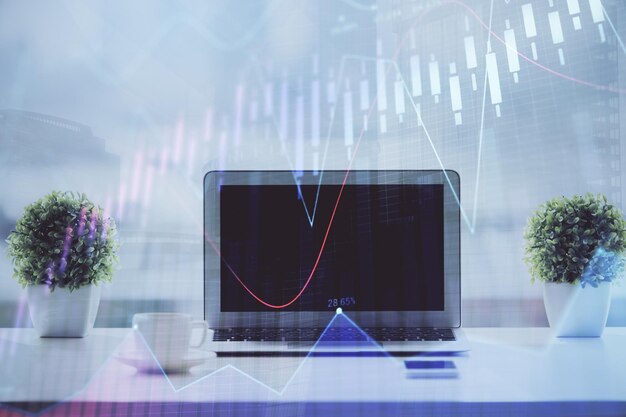 forex graph hologram on table with computer background multi exposure concept of financial markets