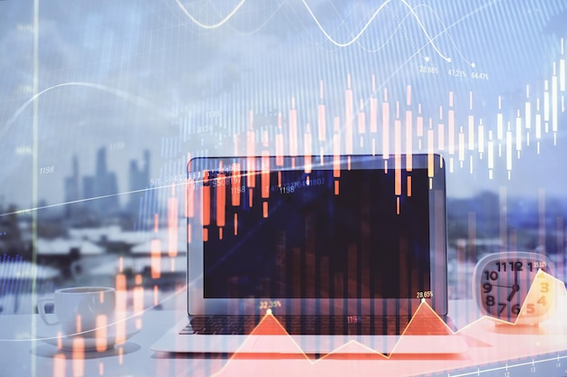 Forex graph hologram on table with computer background Multi exposure Concept of financial markets