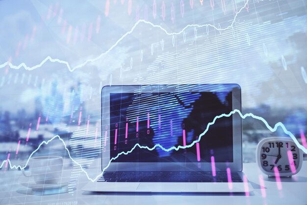 Forex graph hologram on table with computer background Multi exposure Concept of financial markets