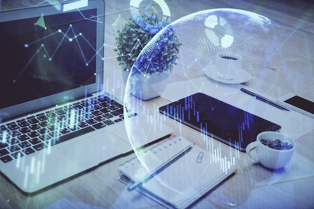 Forex market graph hologram and personal computer on background Multi exposure Concept of investment