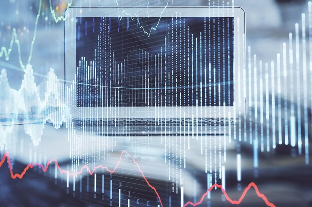 Forex market graph hologram and personal computer on background Multi exposure Concept of investment