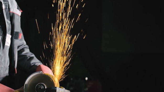 Forge workshop Smithy manual production Sparks industrial worker using angle grinder