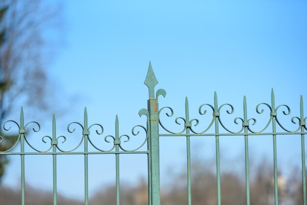 Forged metal fence of the Park on the sky background