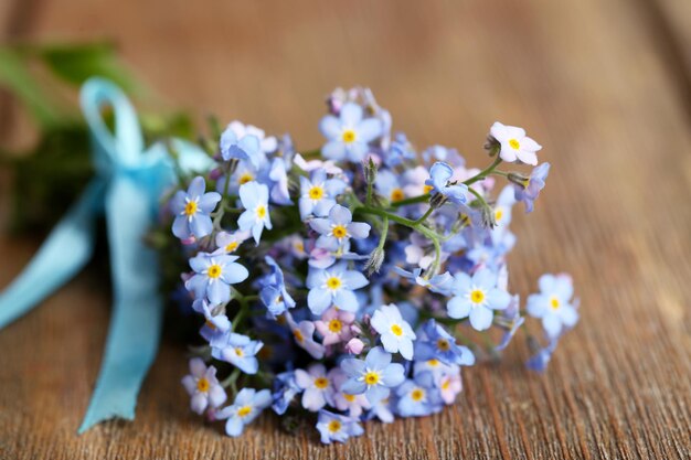 木製の背景にワスレナグサの花