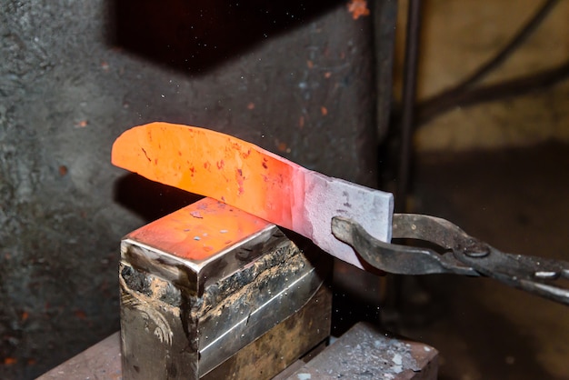 Forging molten metal. Making knives.