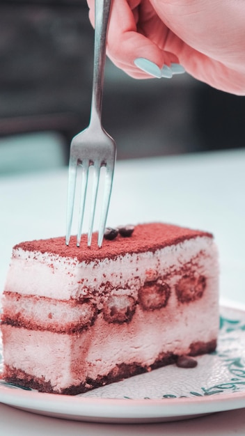 a fork is being used to eat a piece of cake