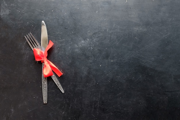 Fork and knife bounded with red tape