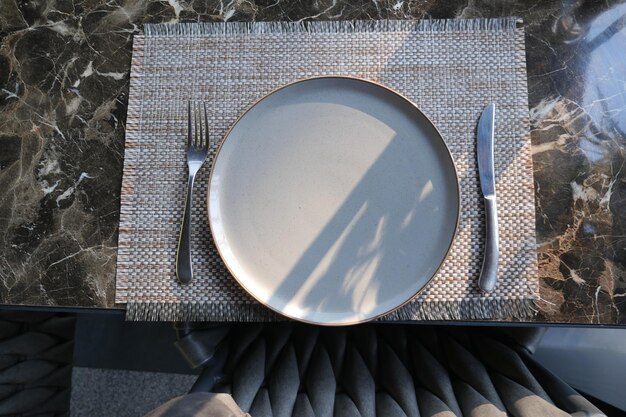 fork knife and a circle shape plate on table