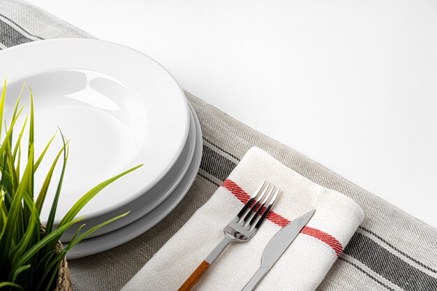 Photo fork, knife and plate on towel. isolated. close up.