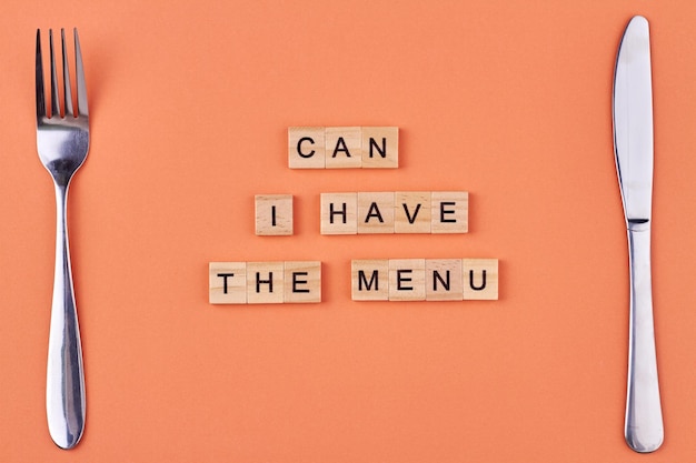 Photo fork knife and text can i have the menu written on wooden cubes