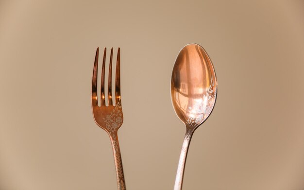 A fork and a spoon are next to each other.