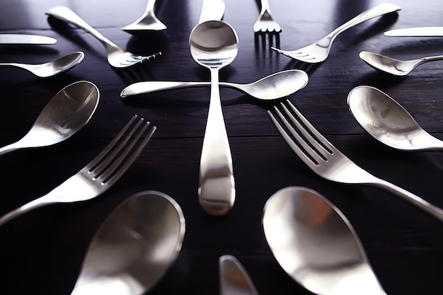 fork spoons knives background / beautiful serving tableware