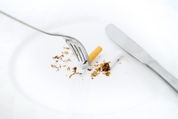 Fork with cigarette on the plate