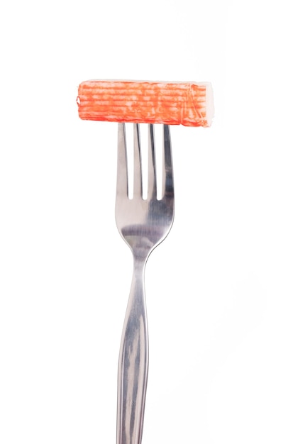 Photo fork with crab stick isolated on white background