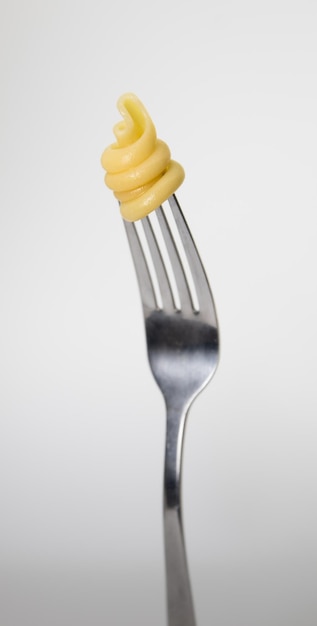 A fork with a fork that has pasta on it.