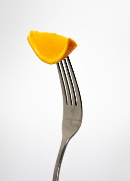 A fork with a piece of mango on it