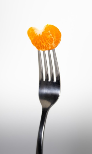 A fork with a piece of orange on it