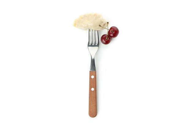 Fork with pierogi with cherry isolated on white background