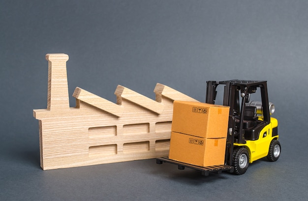 forklift carries cardboard boxes and building a factory or plant services transportation of goods