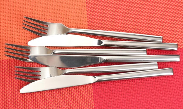 Photo forks and knives on a red tablecloth