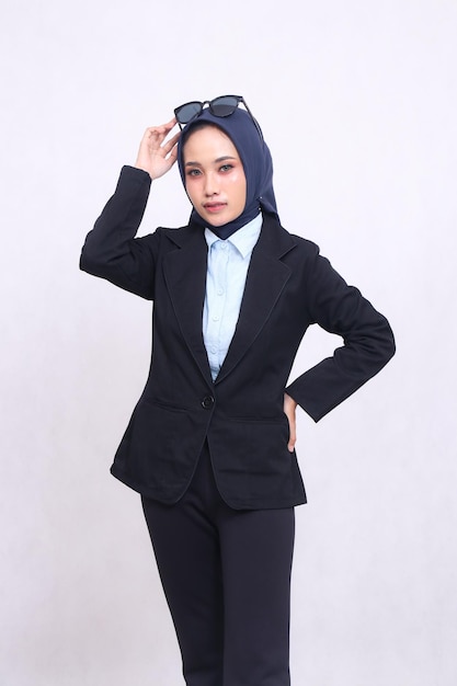 formal asian office woman in blue shirt hijab standing to the camera elegantly hands on waist and ho