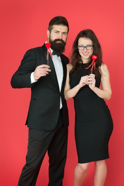 Formal couple. business meeting. tuxedo man and formal woman at\
formal party. sexy couple in love. valentines day heart. bearded\
businessman with formal lady. love date and romance. business\
couple.