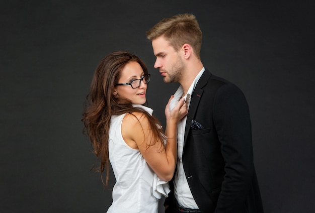 Formal couple in love of man and woman on black background love