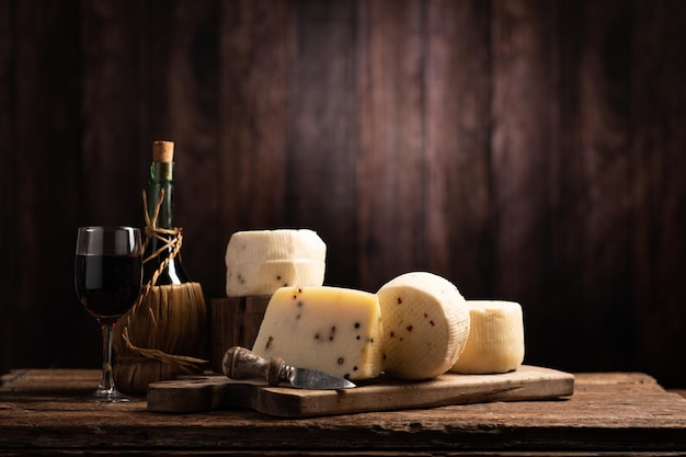 Forms of homemade pecorino cheese on wooden table close up