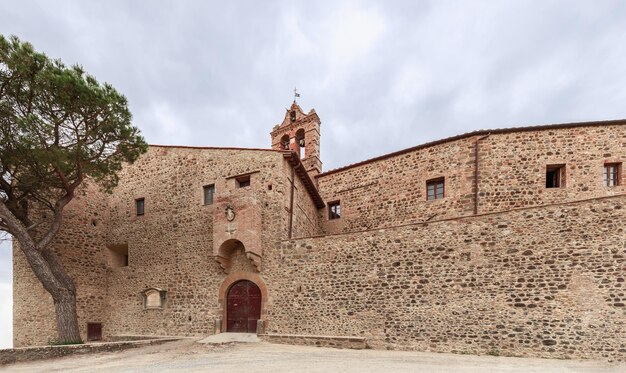 Fortified farm Castelluccio with coat of arms on Hospital of Santa Maria della Scala, Pienza, Italy