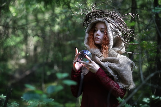 Fortune-teller conducts a ritual in the depths of the forest