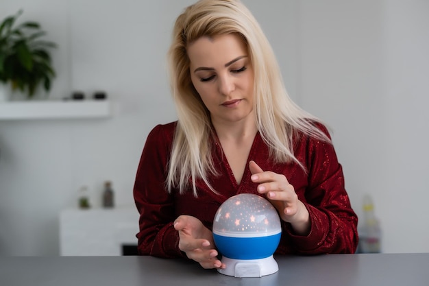 A fortune teller gazes into her ball.