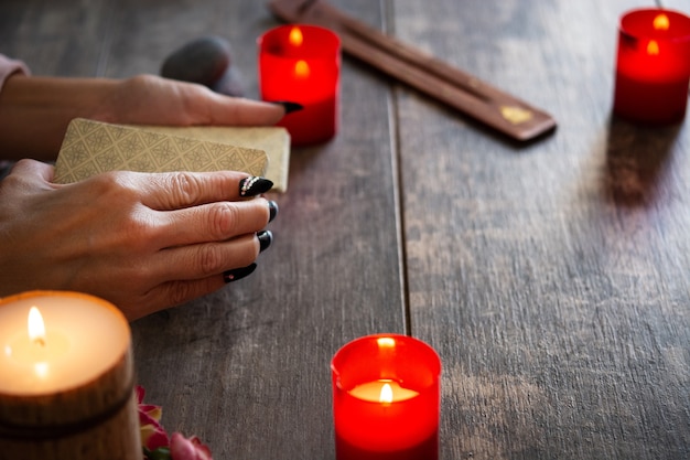 Fortune teller reading a future by tarot cards on rustic table