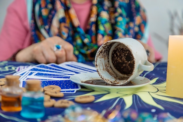 A fortune teller reads fortunes on coffee grounds Selective focus