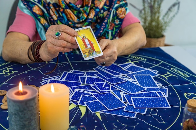 Photo fortune teller reads tarot cards selective focus