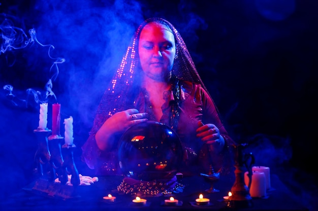 Fortune teller young woman in the saloon calls the spirits Horizontal photo