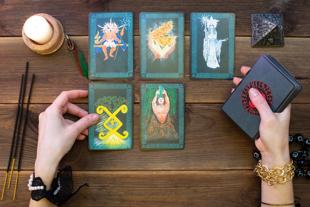 Fortune telling cards, runic cards for fortune telling on a wooden table.