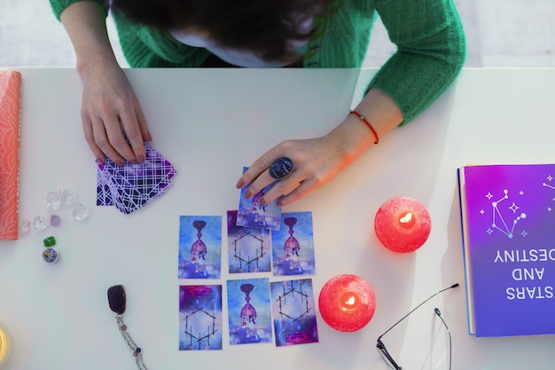 Fortune telling session. Top view of tarot cards being in use while predicting the future