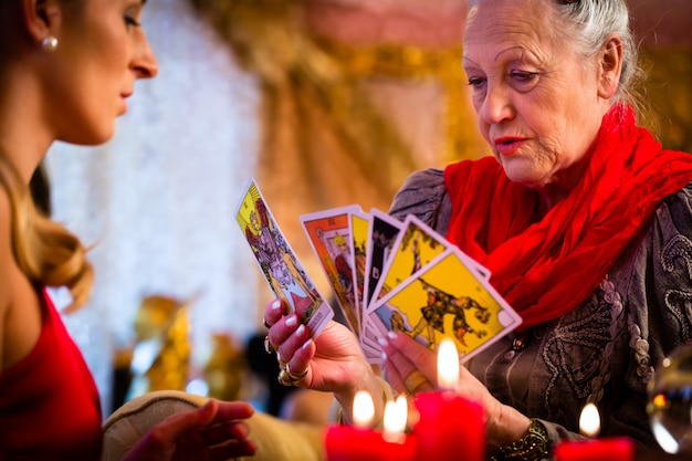 Fortuneteller laying Tarot cards with client