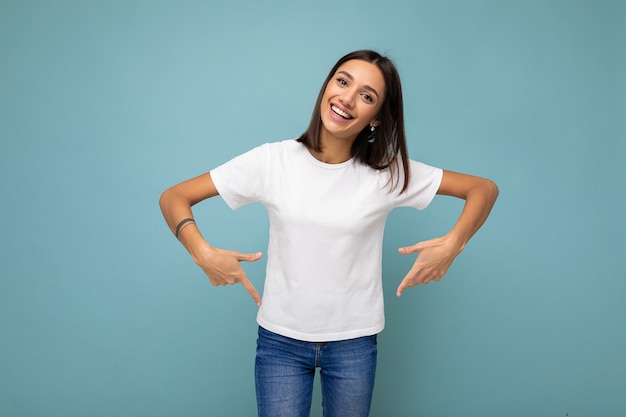 Foto van een positieve, gelukkig lachende jonge charmante brunette vrouw met oprechte emoties die casual draagt