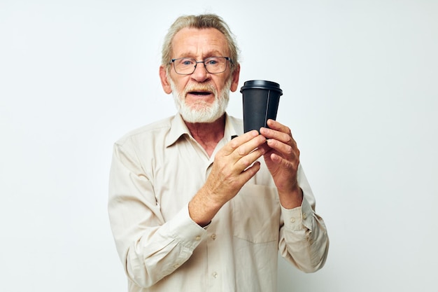 Foto van gepensioneerde oude man in een shirt en bril op een zwarte glazen geïsoleerde achtergrond