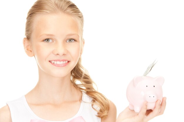 foto van lief tienermeisje met spaarvarken en geld