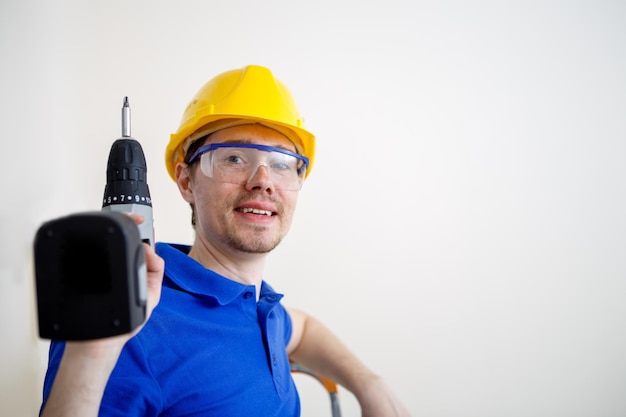 Foto van mannen met boor en in gele helm