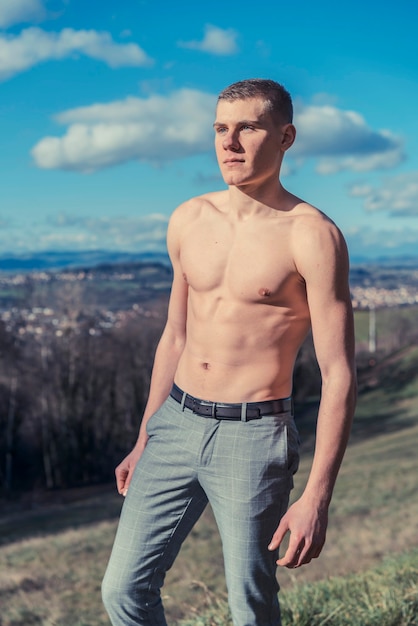 Foto van shirtless man poseren buiten