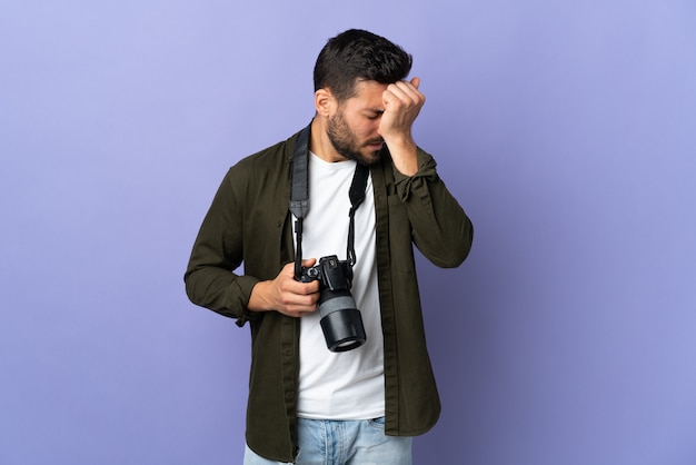 Fotograafmens op geïsoleerde paars met hoofdpijn