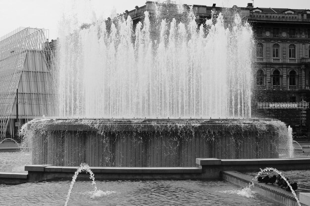 Fountain against building in city