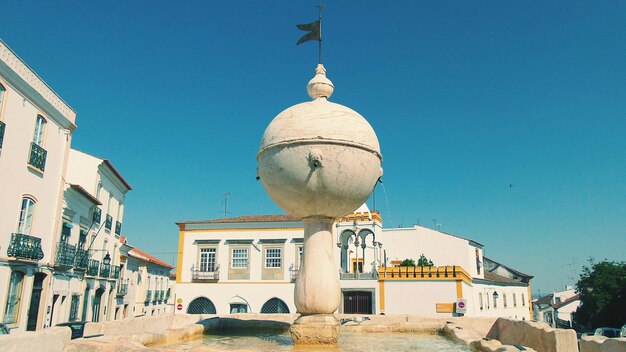 Fountain against residential buildings in city