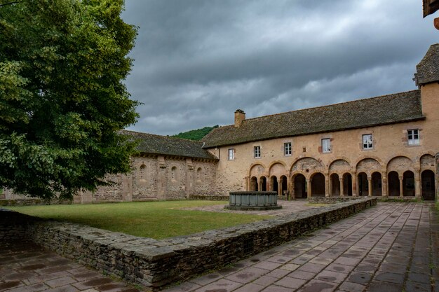 Fountain and arcade in the interior courtyard of the Conques monastery