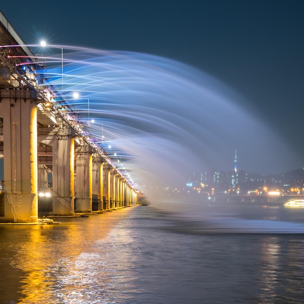 fountain at banpo bridge over han river against sky at night