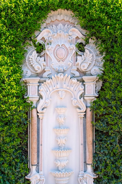 Fountain in the green fence