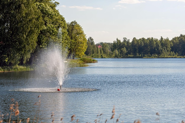 Fountain in the lake water pours from the pipes splashes of water on the lake